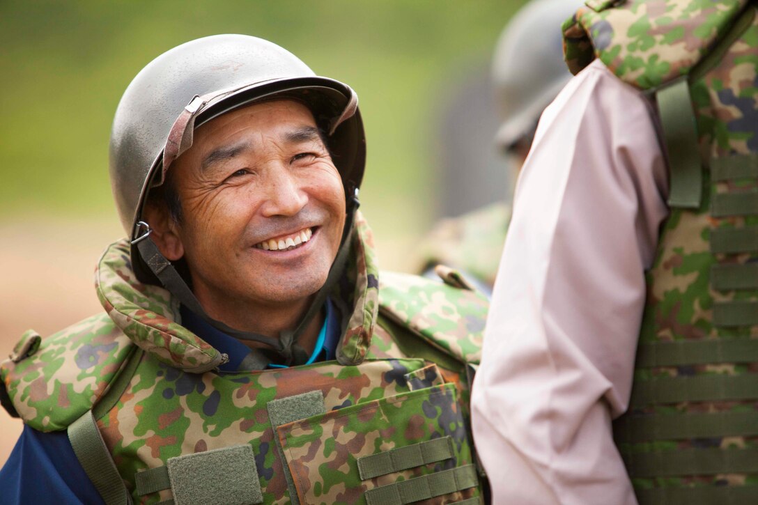 A Japanese citizen listens to an explanation of small arms training during an artillery demonstration for Artillery Relocation Training Program 16-1 in Senjogahara, Japan, May 16, 2016. ARTP is a Japan-funded, routine training exercise that allows Marines with 3rd Battalion, 12th Marine Regiment, 3rd Marine Division, III Marine Expeditionary Force, based out of Camp Hansen, Okinawa, Japan, to conduct live-fire training. ARTP has been conducted in mainland Japan since 1997.