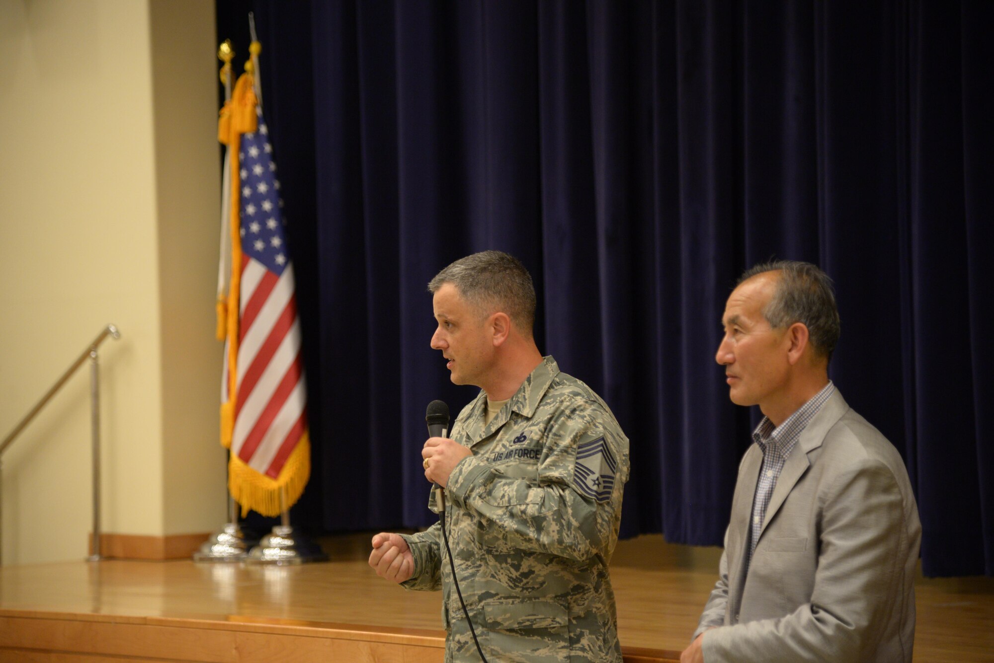 Chief Master Sgt. James Segebarth, 51st Mission Support Group superintendent, gives encouraging advice to the participants of the Osan Good Neighbor English Camp while Yi, Chong Kun, 51st Fighter Wing public affairs community outreach advisor, translates during a ceremony May 18, 2016, in the American Middle School at Osan Air Base, Republic of Korea. The ceremony culminated a three-day English camp where Korean students from the local area had the opportunity to live with a family from Osan AB and learn about American culture. The English Camp program started in 2005 and has helped strengthen the community relationship between local Koreans and American service members and their families. (U.S. Air Force photo by Tech. Sgt. Travis Edwards/Released)