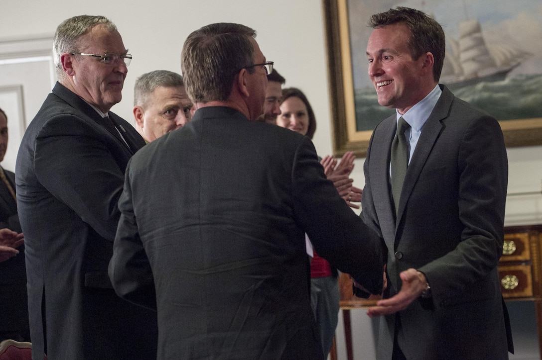 Defense Secretary Ash Carter congratulates Eric Fanning after swearing him in as the Secretary of the Army during a ceremony at the Pentagon, May 18, 2016. DoD photo by Air Force Senior Master Sgt. Adrian Cadiz