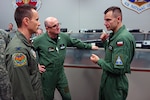Dan McSeveney, left, commander of the 183d Combat Operations Squadron,discusses air operations with Brig. Gen. Slawomir Zakowski, center, and Col. Robert Weissgerber, right, from the Air Operations Center-Air Component Command, Warsaw, Poland, during a simulated battle exercise as part of an information and training exchange visit May 12 - 16, 2016, in Springfield, Ill.