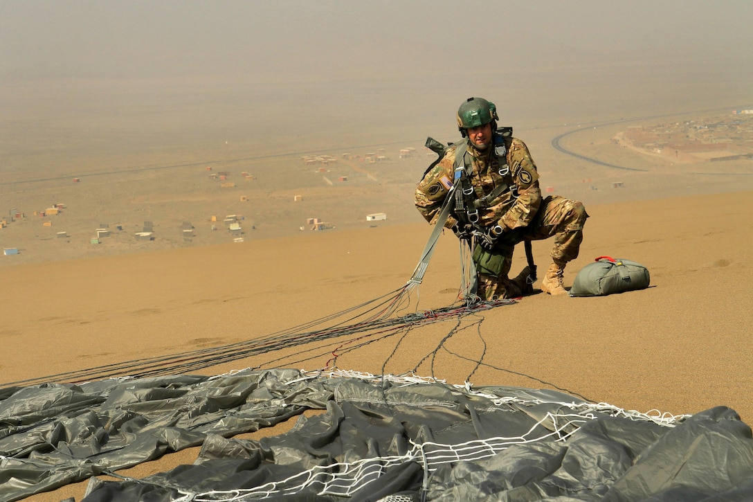 A U.S. Special Forces soldier prepares to remove his parachute harness and recover his chute during the closing event of Fuerzas Comando 2016 in Ancon, Peru, May 11, 2016. Army photo by Spc. Jaccob Hearn