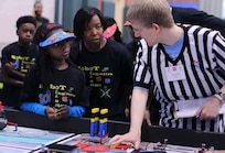 RICHMOND, Va. – Naval Surface Warfare Center Dahlgren Division (NSWCDD) engineer Serita Seright, 2nd from right, and a student, listen to a judge explain the FIRST LEGO League (FLL) competition rules and point system at Maggie Walker Governor High School in November 2015. Seright – who mentors a FLL student team called the “Robot Engineers" – was honored by the National Society of Black Engineers (NSBE) as the Region II "Professionals Member of the Year" for leadership impacting its mission in Virginia, NSWCDD announced, May 16. “I'm humbled to be recognized for personifying the NSBE mission – to increase the number of culturally responsible black engineers who excel academically, succeed professionally, and positively impact the community," said Seright, in response to the news. The  award recognizes individuals who make outstanding contributions to NSBE, especially their chapter and region, in the areas of leadership, excellence, service, and advancement of its programs and mission.