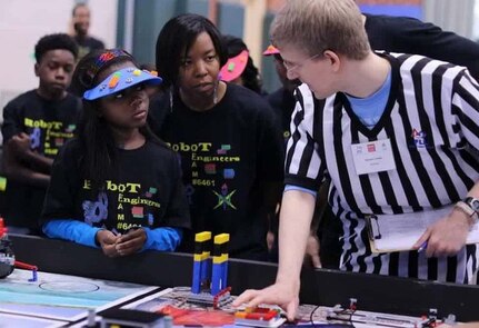 RICHMOND, Va. – Naval Surface Warfare Center Dahlgren Division (NSWCDD) engineer Serita Seright, 2nd from right, and a student, listen to a judge explain the FIRST LEGO League (FLL) competition rules and point system at Maggie Walker Governor High School in November 2015. Seright – who mentors a FLL student team called the “Robot Engineers" – was honored by the National Society of Black Engineers (NSBE) as the Region II "Professionals Member of the Year" for leadership impacting its mission in Virginia, NSWCDD announced, May 16. “I'm humbled to be recognized for personifying the NSBE mission – to increase the number of culturally responsible black engineers who excel academically, succeed professionally, and positively impact the community," said Seright, in response to the news. The  award recognizes individuals who make outstanding contributions to NSBE, especially their chapter and region, in the areas of leadership, excellence, service, and advancement of its programs and mission.