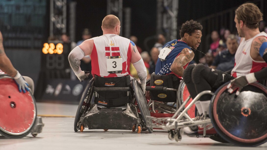 Marine Sgt. Anthony McDaniel (ret.), center, from Pascagoula, Mississippi, plays in a wheel chair basketball game at the Invictus Games in Orlando Florida, May 11, 2016. The Invictus Games are an international Paralympic-style multi-sport event, created by Britain's Prince Harry, in which wounded, injured or sick armed services personnel and their associated veterans take part in sports including wheelchair basketball, sitting volleyball, and indoor rowing.