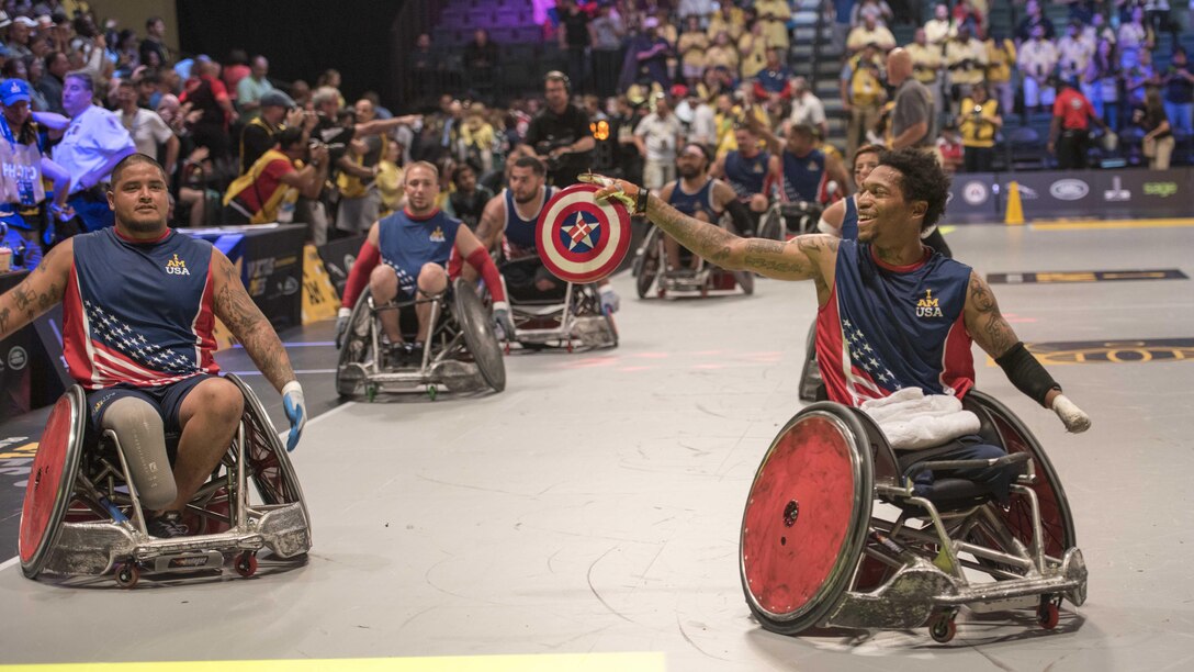 Marine Sgt. Anthony McDaniel (ret.), right, from Pascagoula, Mississippi, celebrates after playing in a wheel chair basketball game at the Invictus Games in Orlando Florida, May 11, 2016. The Invictus Games are an international Paralympic-style multi-sport event, created by Britain's Prince Harry, in which wounded, injured or sick armed services personnel and their associated veterans take part in sports including wheelchair basketball, sitting volleyball, and indoor rowing.