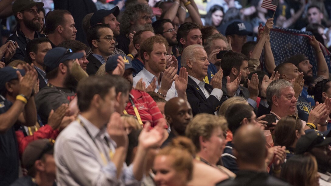 His Royal Highness Prince Henry of Wales and Joe Biden, vice president of the United States, applaud participants during a wheel chair basketball game at the Invictus Games in Orlando Florida, May 11, 2016. The Invictus Games are an international Paralympic-style multi-sport event, created by Britain's Prince Harry, in which wounded, injured or sick armed services personnel and their associated veterans take part in sports including wheelchair basketball, sitting volleyball, and indoor rowing.
