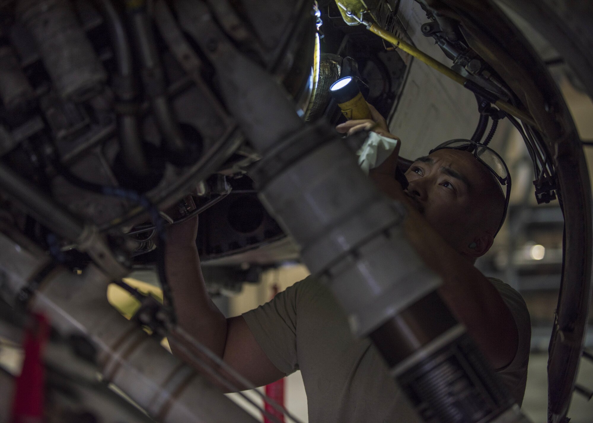 Technical Sgt. Rene Garcia, 455th Expeditionary Aircraft Maintenance Squadron phase technician, inspects the interior of an F-16C Fighting Falcon during routine phase maintenance at Bagram Airfield, Afghanistan, May 18, 2016. This aircraft is going through phase maintenance where members of the 455th EAMS phase flight closely inspect the aircraft for cracks and other types of damage, verifying that the 30 plus year old aircraft is safe to fly. (U.S. Air Force photo by Senior Airman Justyn M. Freeman)