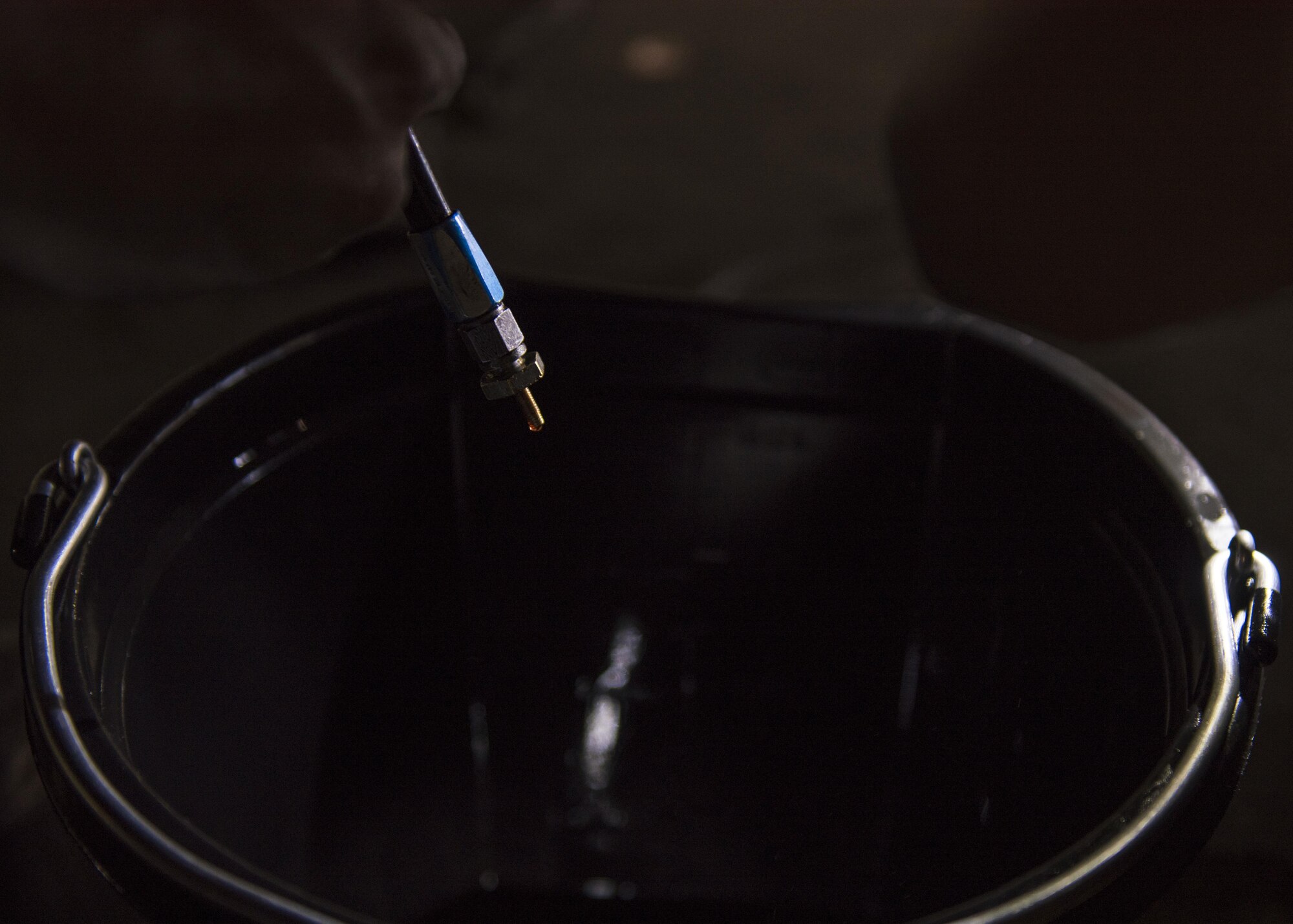 Senior Airman Jonathan Clark, 455th Expeditionary Aircraft Maintenance Squadron phase technician, clears the brake lines of fluid on an F-16C Fighting Falcon during routine phase maintenance at Bagram Airfield, Afghanistan, May 18, 2016. Phase Airmen are assigned specific sections of the aircraft to ensure it is thoroughly inspected. (U.S. Air Force photo by Senior Airman Justyn M. Freeman)
