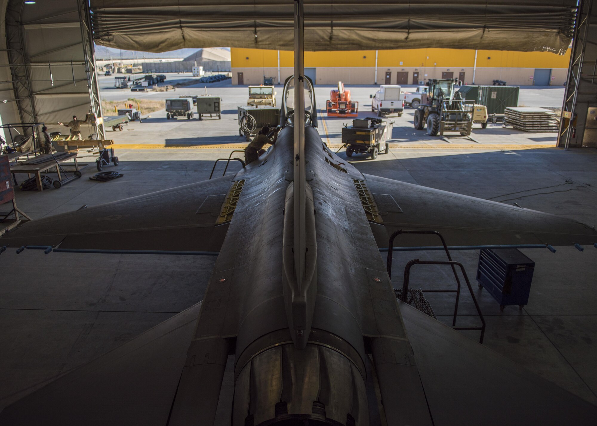 455th Expeditionary Aircraft Maintenance Squadron phase technicians, work on an F-16C Fighting Falcon during routine phase maintenance at Bagram Airfield, Afghanistan, May 18, 2016. Phase inspections are performed on aircraft every 300 flight hours and involve procedural maintenance actions that require robust attention to detail. (U.S. Air Force photo by Senior Airman Justyn M. Freeman)
