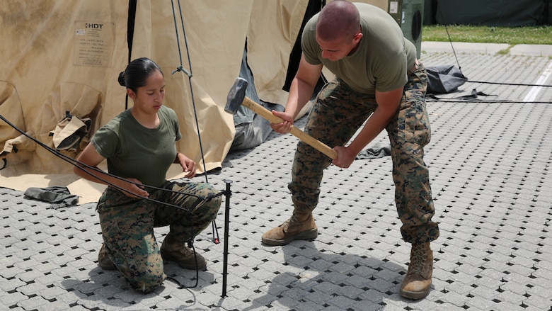 Lance Cpl. Florencia Murrillotorres and Lance Cpl. Johnny E. Rodriguez pound stakes into the ground while pitching tents to house more than 300 Marines during Marine Expeditionary Force Exercise 2016, at Marine Corps Air Station Cherry Point, N.C., May 11, 2016. MEFEX 16 is designed to synchronize and bring to bear the full spectrum of II MEF’s command and control capabilities in support of a Marine Air-Ground Task Force. 