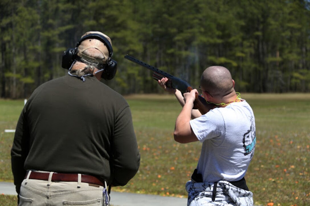 Kevin Driscoll (left) supervises Cpl. Joshua Wade during a trap and skeet range at Marine Corps Air Station Cherry Point, N.C., April 14, 2016. Twenty Marines with 2nd Low Altitude Air Defense Battalion’s Firearms Mentorship Program utilized their marksmanship skills during the range as part of their firearms safety classes. The mentorship program promotes safe private gun ownership, builds confidence in marksmanship skills and increases Marines combat readiness by familiarizing them with other weapons. Driscoll is the range safety officer with the MCAS Cherry Point Skeet Club and Wade is a ground radio operator with the battalion. (U.S. Marine Corps photo by Cpl. N.W. Huertas/ Released)