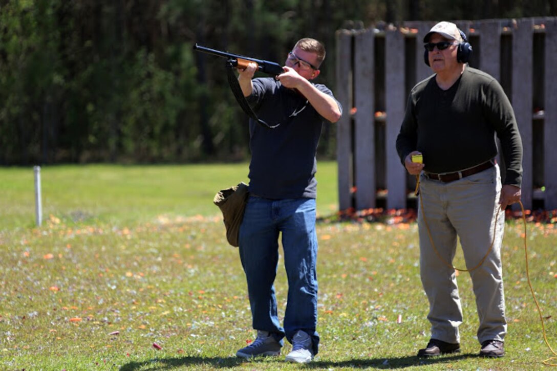 Pfc. Jesse Conti (left) receives guidance from Kevin Driscoll during a trap and skeet range at Marine Corps Air Station Cherry Point, N.C., April 14, 2016. Twenty Marines with 2nd Low Altitude Air Defense Battalion’s Firearms Mentorship Program utilized their marksmanship skills during the range as part of their firearms safety classes. The mentorship program promotes safe private gun ownership, builds confidence in marksmanship skills and increases Marines combat readiness by familiarizing them with other weapons. Conti is a low altitude air defense gunner with the battalion and Driscoll is the range safety officer with the MCAS Cherry Point Skeet Club. (U.S. Marine Corps photo by Cpl. N.W. Huertas/ Released) 