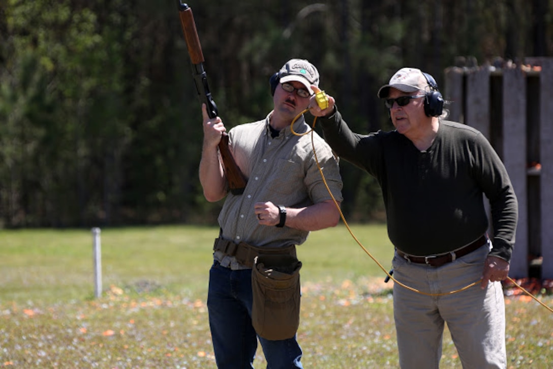 Cpl. Stephen Gomes (left) receives guidance from Kevin Driscoll during a trap and skeet range at Marine Corps Air Station Cherry Point, N.C., April 14, 2016. Twenty Marines with 2nd Low Altitude Air Defense Battalion’s Firearms Mentorship Program utilized their marksmanship skills during the range as part of their firearms safety classes. The mentorship program promotes safe private gun ownership, builds confidence in marksmanship skills and increases Marines combat readiness by familiarizing them with other weapons. Gomes is a cyber-network operator with the battalion and Driscoll is the range safety officer with the MCAS Cherry Point Skeet Club. (U.S. Marine Corps photo by Cpl. N.W. Huertas/ Released)