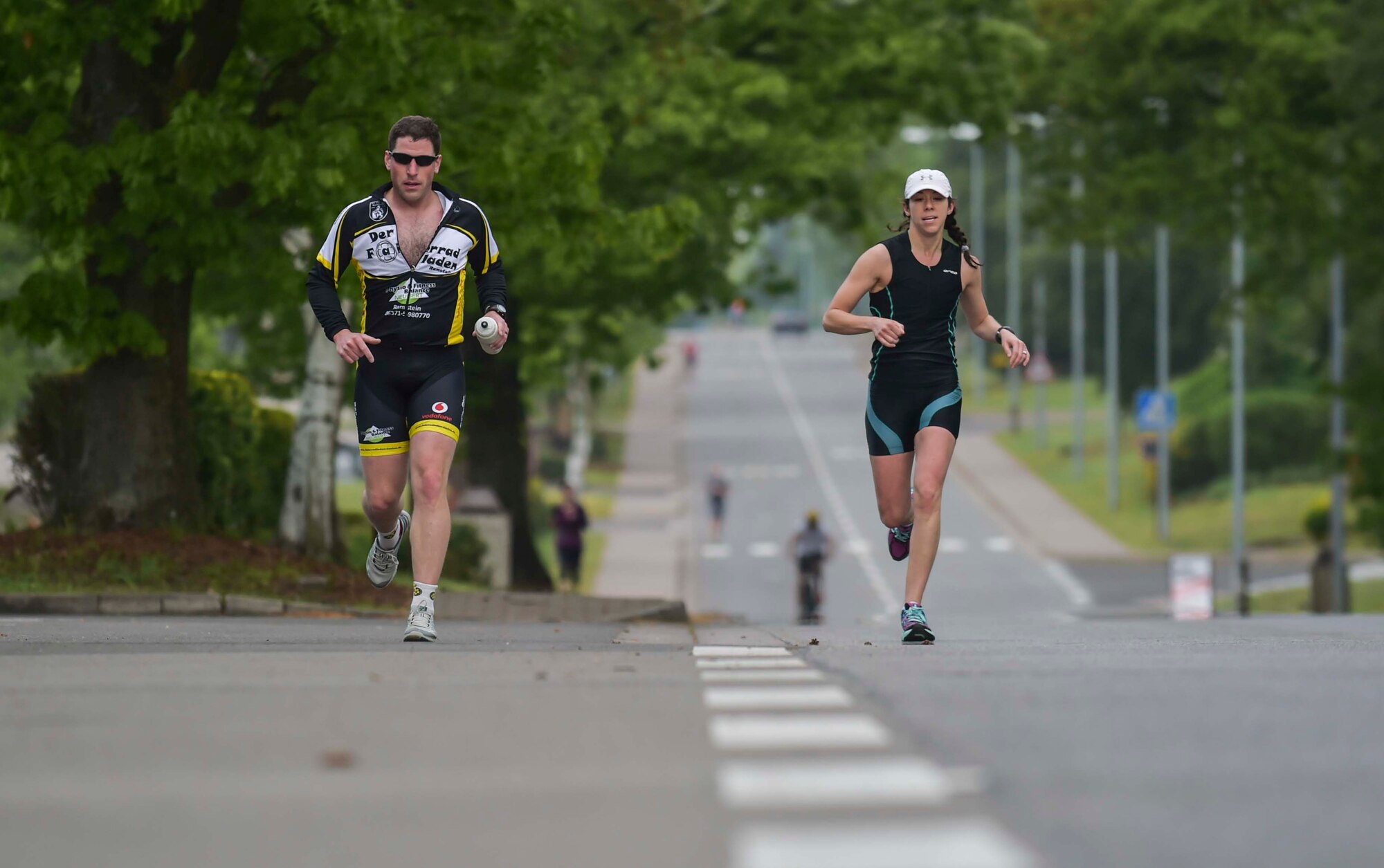 Ramstein Airmen and their families compete in the run portion of the Michael Hill Memorial Triathlon at Ramstein Air Base, Germany, May 14, 2016. The triathlon included three portions; 275 m swim, 20 km bike and 5 km run. All proceeds collected for the event were donated to a charity in Michael Hill’s name. (U.S. Air Force photo by/Tech Sgt. Sara Keller)
