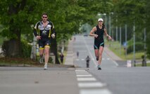 Ramstein Airmen and their families compete in the run portion of the Michael Hill Memorial Triathlon at Ramstein Air Base, Germany, May 14, 2016. The triathlon included three portions; 275 m swim, 20 km bike and 5 km run. All proceeds collected for the event were donated to a charity in Michael Hill’s name. (U.S. Air Force photo by/Tech Sgt. Sara Keller)