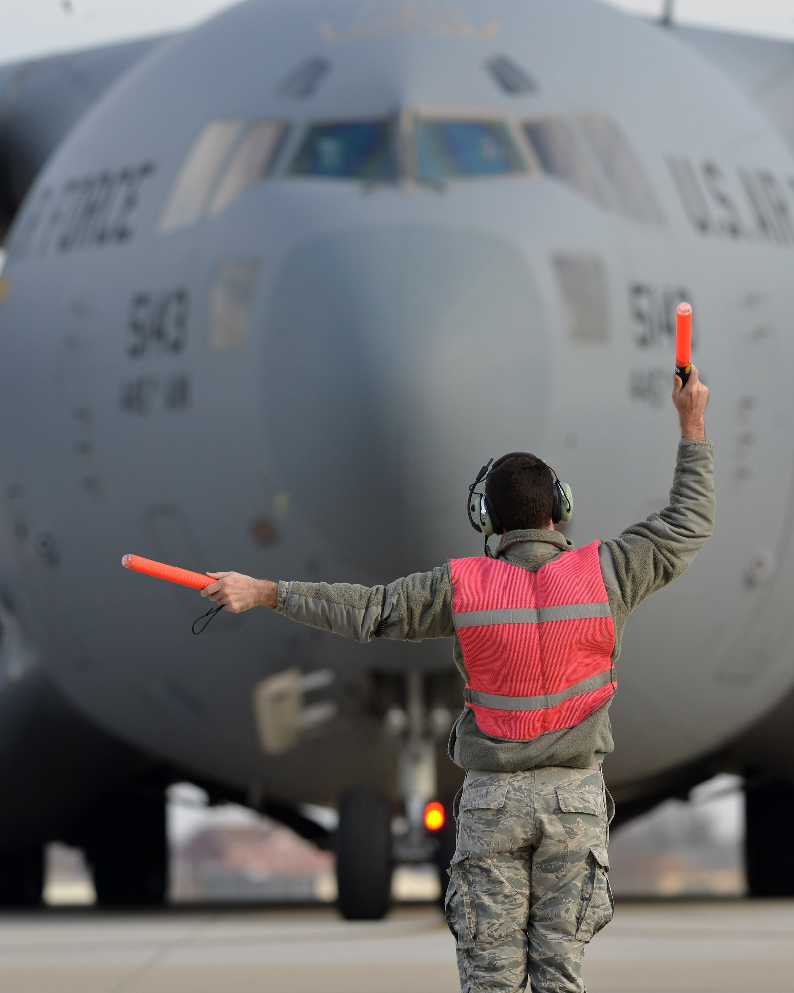 Senior Airman Cody Burdette, 445th Aircraft Maintenance Squadron aircraft mechanic, marshals a 445th Airlift Wing C-17 Globemaster III out of its spot on the ramp for a local flight. The wing has nine C-17s in its inventory. The design of the aircraft allows it to operate through small, austere airfields. It can take off and land on runways as short as 3,500 feet and only 90 feet wide. (U.S. Air Force photo/Tech. Sgt. Frank Oliver)
