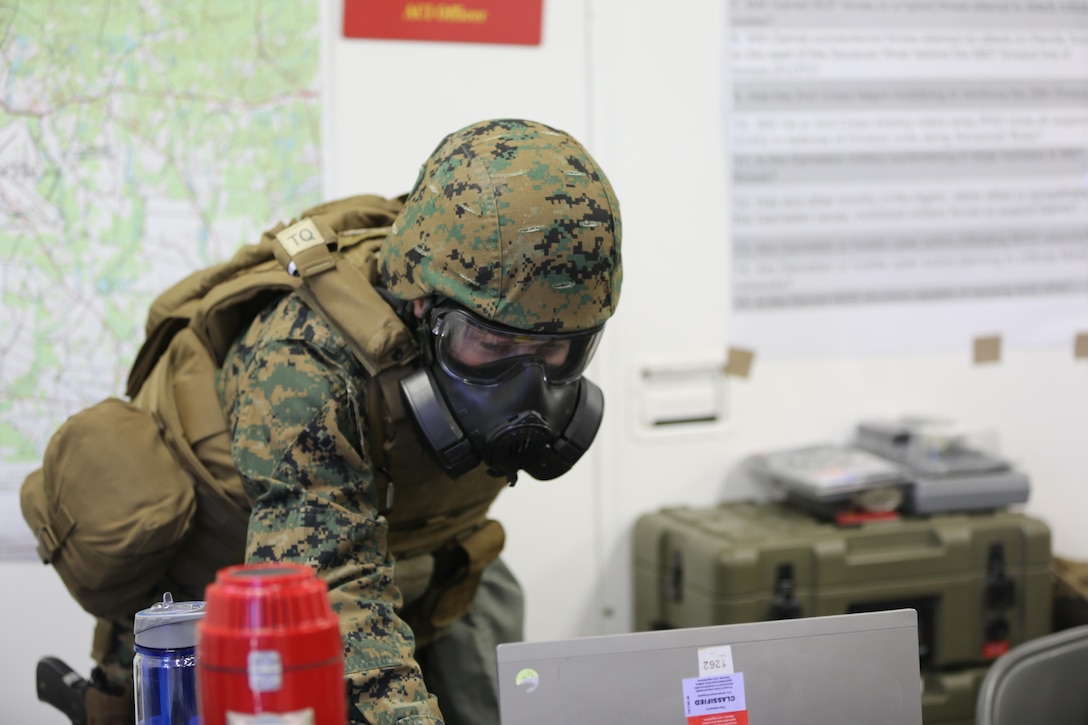 1st Lt. Jacqueline Fisher continues to work while wearing a gas mask during a mock chemical, biological, radiological and nuclear defense drill, during 2nd Marine Aircraft Wing’s portion of the II Marine Expeditionary Force Exercise 2016 at Marine Corps Air Station Cherry Point, N.C., May 15, 2016. During MEFEX 16, 2nd MAW conducted an incoming CBRN drill to ensure that the Marines knew how to react quickly and use their equipment properly. MEFEX 16 is designed to synchronize and bring to bear the full spectrum of II MEF’s command and control capabilities in support of the Marine Air-Ground Task Force. Fisher is an air intelligence officer with Marine Wing Headquarters Squadron 2. (U.S. Marine Corps photo Staff Sgt. Rebekka S. Heite/Released)