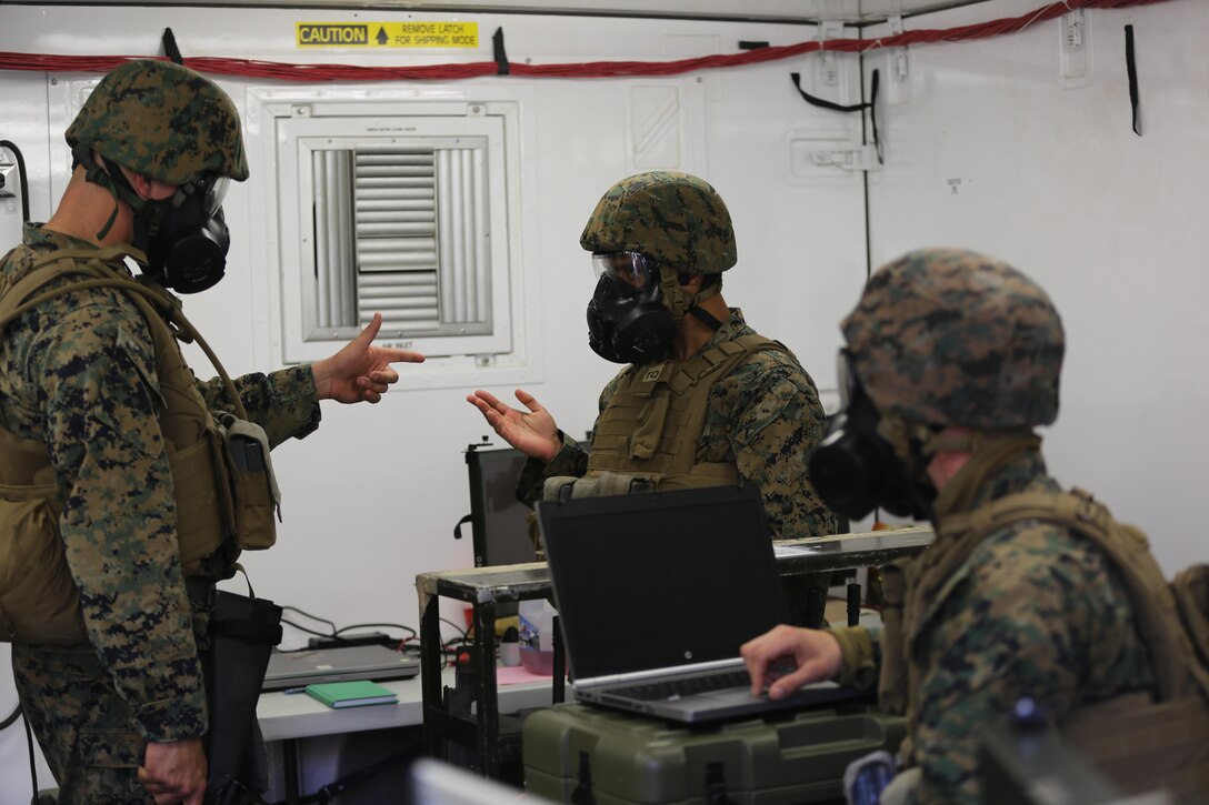 Marines communicate with each other during a mock chemical, biological, radiological and nuclear defense drill in 2nd Marine Aircraft Wing’s portion of the II Marine Expeditionary Force Exercise 2016 at Marine Corps Air Station Cherry Point, N.C. May 15, 2016. The purpose of the drill was to ensure that the Marines knew how to react quickly and use their equipment properly. MEFEX 16 is designed to synchronize and bring to bear the full spectrum of II MEF’s command and control capabilities in support of the Marine Air-Ground Task Force. (U.S. Marine Corps photo by Staff Sgt. Rebekka S. Heite/Released)