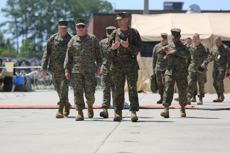 Maj. Gen. Walter Lee Miller, Jr., the II Marine Expeditionary Force commanding general conducts a site survey guided by Lt. Col. Bradley Phillips, commanding officer of Marine Tactical Air Control Squadron 28. Miller reviewed the operations compound during 2nd Marine Aircraft Wing’s portion of MEFEX 16 at Marine Corps Air Station Cherry Point, N.C., May 16, 2016.  MEFEX 16 is designed to synchronize and bring to bear the full spectrum of II MEF’s command and control capabilities in support of the Marine Air-Ground Task Force. (U.S. Marine Corps photo by Lance Cpl. Mackenzie Gibson/Released)