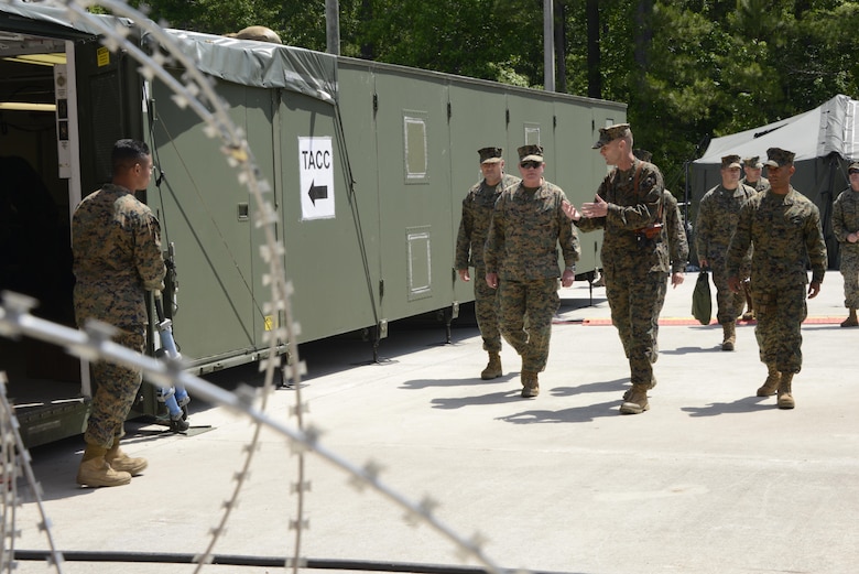 Maj. Gen. Walter Lee Miller, Jr., the II Marine Expeditionary Force commanding general conducts a site survey guided by Lt. Col. Bradley Phillips, commanding officer of Marine Tactical Air Control Squadron 28. Miller reviewed the operations compound during 2nd Marine Aircraft Wing’s portion of MEFEX 16 at Marine Corps Air Station Cherry Point, N.C., May 16, 2016.  MEFEX 16 is designed to synchronize and bring to bear the full spectrum of II MEF’s command and control capabilities in support of the Marine Air-Ground Task Force. (U.S. Marine Corps photo by Staff Sgt. Rebekka Heite/Released)