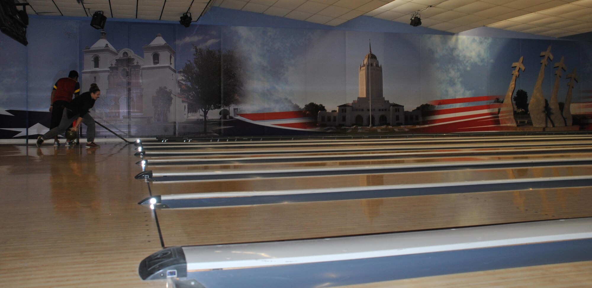 The 80 Air Force bowling centers worldwide offer programs and activities for Airmen and their families in a safe environment. The center at Joint Base San Antonio-Randolph, Texas, recently installed murals paying homage to the base history. Behind the scenes, a new bowling management system controls every aspect of the game, including scoring and foul lights. (U.S. Air Force photo/Carole Chiles Fuller/Released)