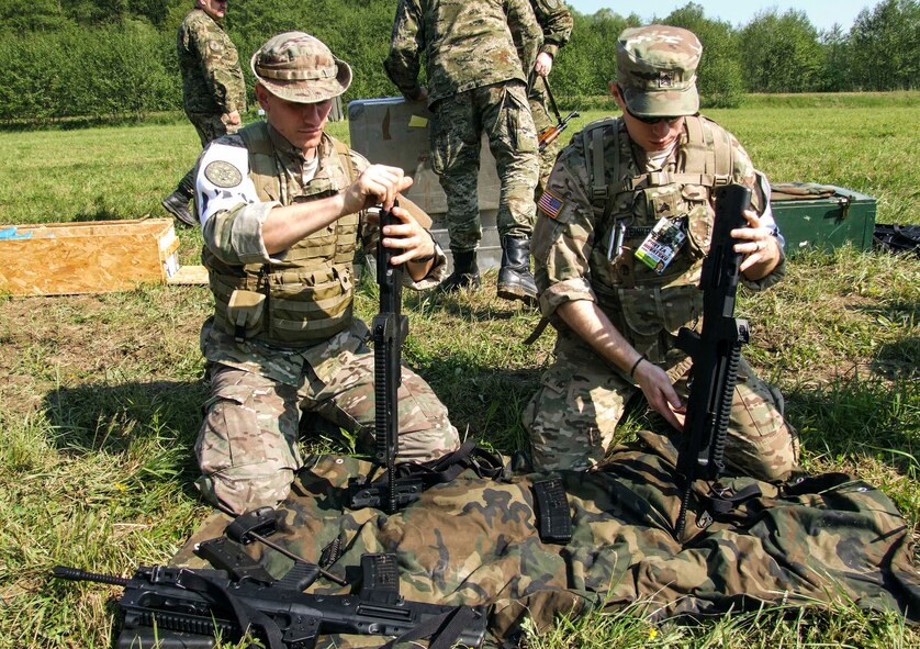 Senior Airman Tormod Lillekroken, 2nd Air Support Operations Squadron joint terminal attack controller, and a U.S. Army Soldier reassemble a weapon as part of one of the challenges during the Croatian Best Soldier Competition in Grubišno Polje, Croatia, May 12, 2016. Nine U.S. service members, including five Airmen were among the first U.S. service members to ever complete the multi-day challenge that included 28 check points and 12 work stations that challenged competitors in the shooting, medical care, kayaking, weapons assembly and more. (Courtesy photo) 