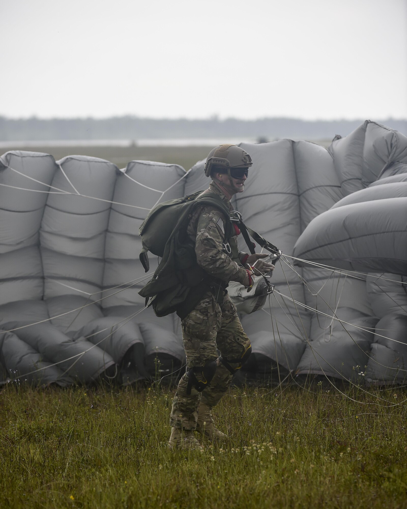 Chief Master Sgt. Bruce Dixon, the command chief master sergeant of the 24th Special Operations Wing, gathers a parachute following the final jump of his career at Hurlburt Field, Fla., May 3, 2016. Dixon, who is retiring after a 30-year career as a combat controller, is one of a handful of military members to complete three freefall jumps into combat since the Vietnam War. (U.S. Air Force photo by Airman 1st Class Kai White)  
