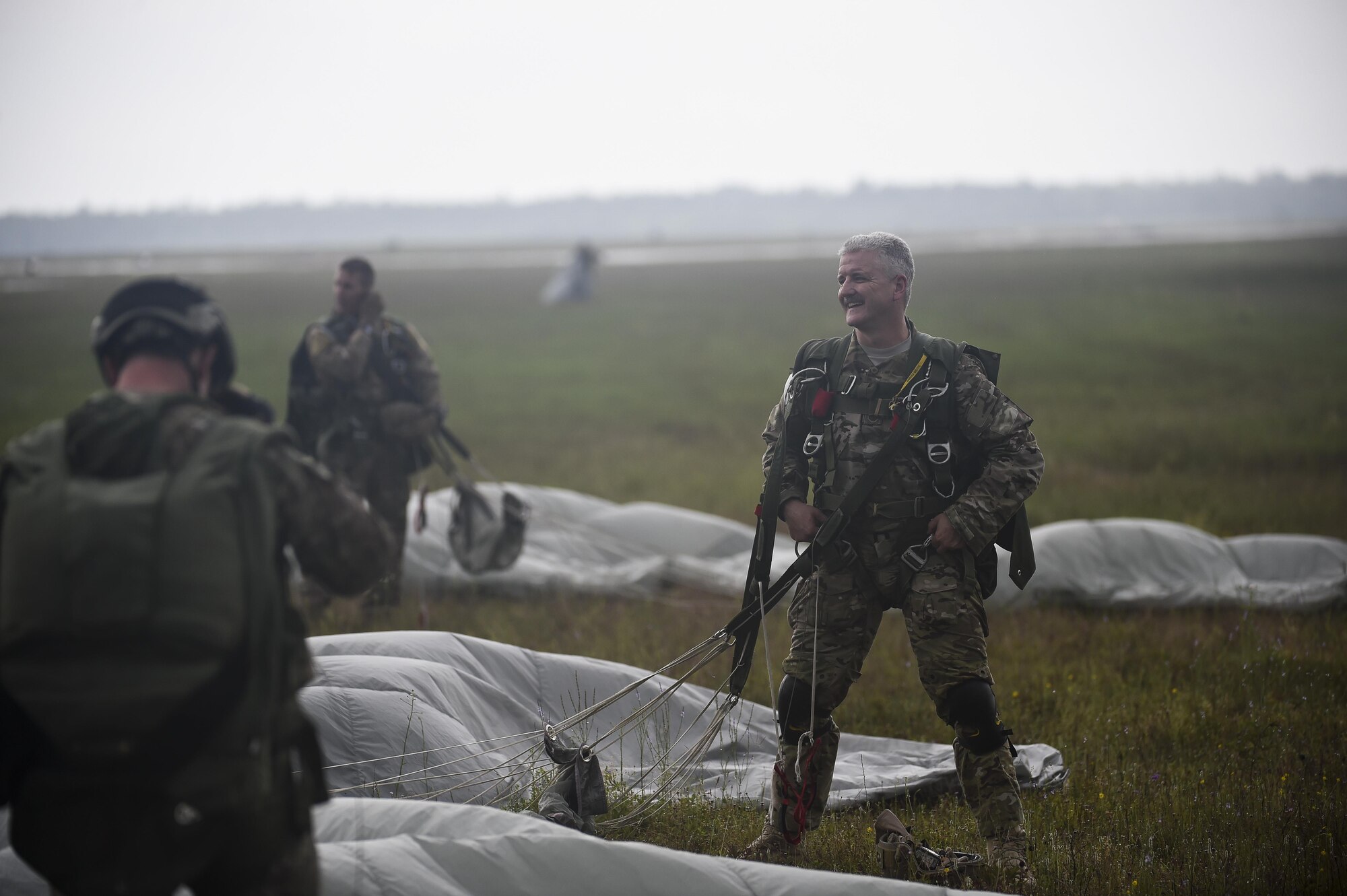Chief Master Sgt. Bruce Dixon, the command chief master sergeant of the 24th Special Operations Wing, gathers a parachute after conducting his final military jump at Hurlburt Field, Fla., May 3, 2016. Dixon, who is retiring after a 30-year career as a combat controller, is one of a handful of military members to complete three free-fall jumps into combat since the Vietnam War. (U.S. Air Force photo by Airman 1st Class Kai White) 