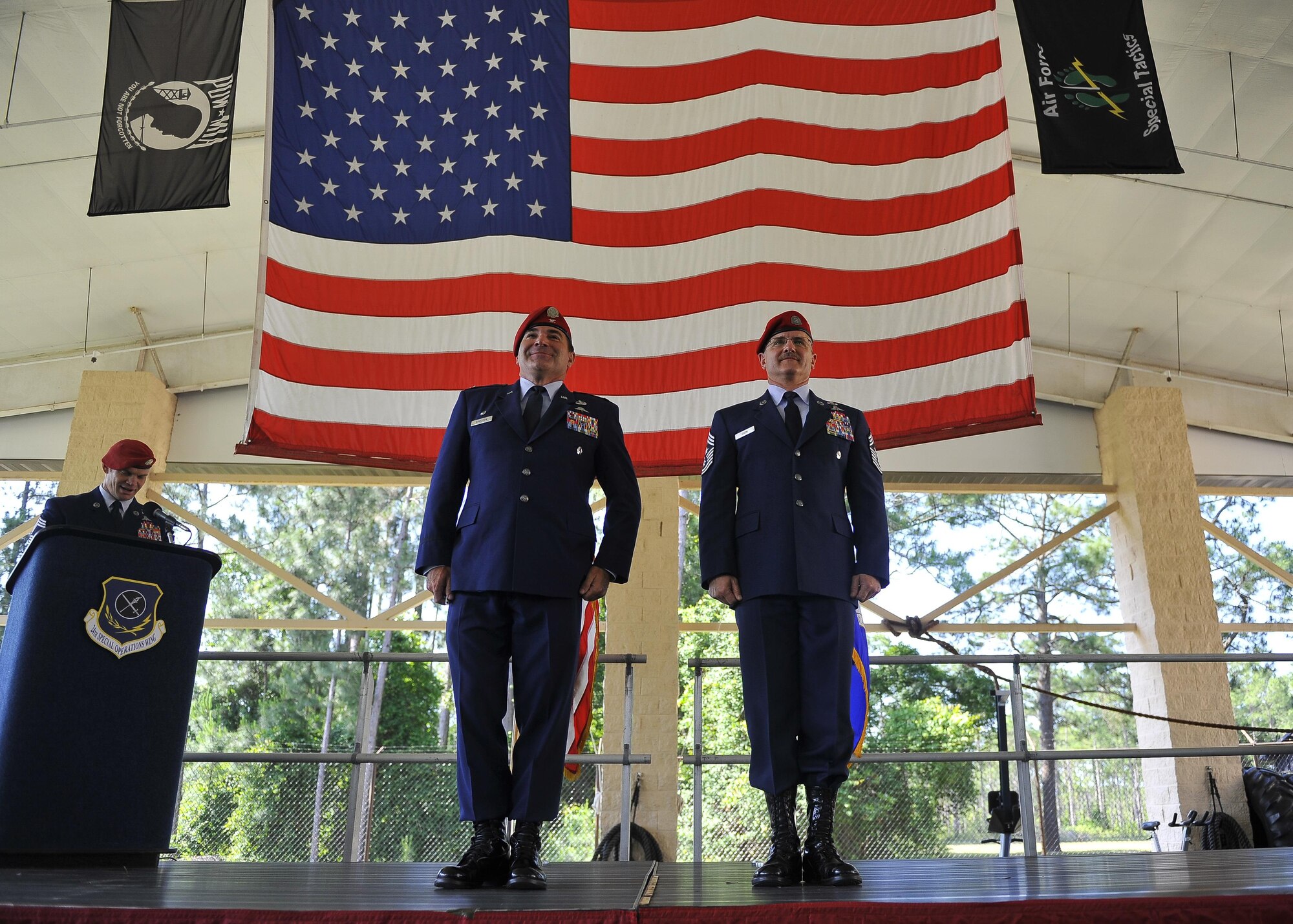 Col. Matthew Davidson, the commander of the 24th Special Operations Wing, and Chief Master Sgt. Bruce Dixon, the command chief master sergeant of the 24th SOW, stand at attention during the reading of Dixon's Legion of Merit Medal citation during his retirement ceremony at Hurlburt Field, Fla., May 13, 2016. Dixon served 30 years as a combat controller, earning the title of master parachutist with more than 400 military jumps including three combat jumps in Afghanistan. In total, he spent ten of those thirty years away from his family, consistently serving his nation's call in dangerous ground combat and training. (U.S. Air Force photo by Airman 1st Class Kai White)