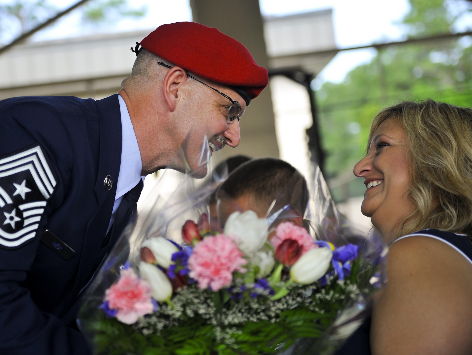 Chief Master Sgt. Bruce W. Dixon, the command chief of the 24th Special Operations Wing, presents his wife, Lori Dixon, with flowers during his retirement ceremony at Hurlburt Field, Fla., May 13, 2016. Dixon served 30 years as a combat controller, earning the title of master parachutist with more than 400 military jumps including three combat jumps in Afghanistan. In total, he spent ten of those thirty years away from his family, consistently serving his nation's call in dangerous ground combat and training. (U.S. Air Force photo by Airman 1st Class Kai White) 