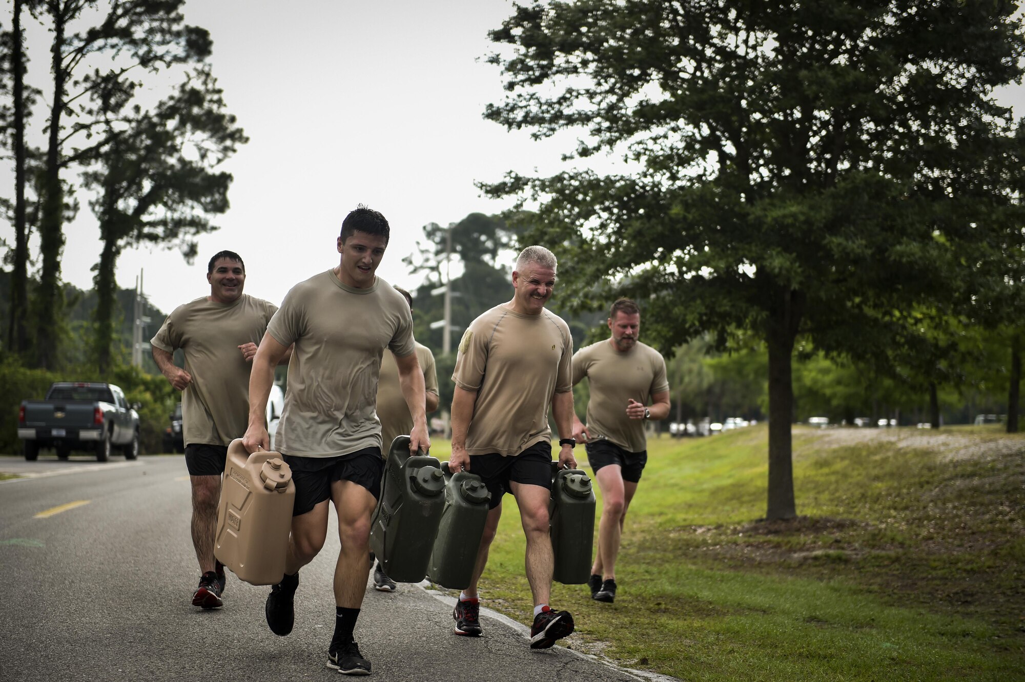 Monster Mash Team 4 finishes an obstacle course carrying 50-pound fuel containers at Hurlburt Field, Fla., May 12, 2016. Monster Mash is a long-standing Special Tactics training tradition, consisting of an obstacle course where special operators complete timed scenarios at different stations of core mission training. The event was held in honor of Chief Master Sgt. Bruce W. Dixon, the command chief of the 24th Special Operations Wing, who is retiring after a 30-year career as a combat controller. (U.S. Air Force photo by Senior Airman Ryan Conroy)   