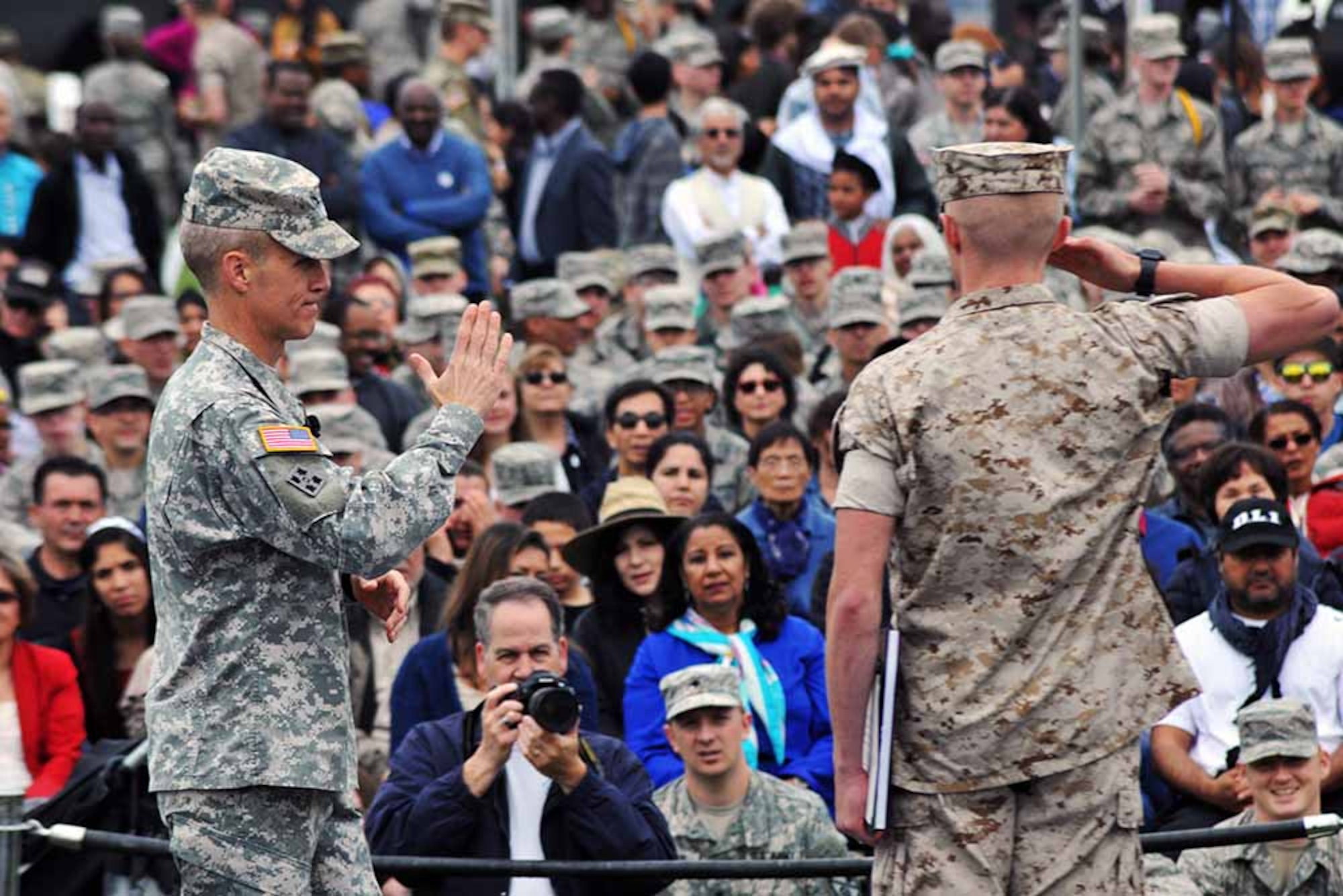 A U.S. Marine Corps student at the Defense Language Institute Foreign Language Center salutes after being recognized by the commandant, Col. Phillip J. Deppert, during Language Day 2016 at the Presidio of Monterey, California, May 13. Language Day is an annual open-house event that promotes and encourages cultural understanding and customs from around the world. (Photo by Patrick Bray, DLIFLC Public Affairs)
