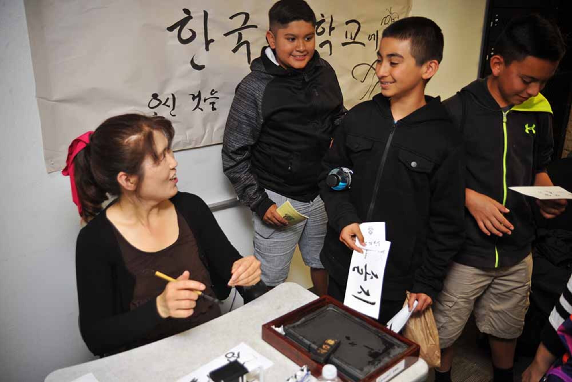 Kim Myung-su, a Korean language instructor, interacts with visiting students during Language Day 2016 at the Presidio of Monterey, California, May 13. Language Day is an annual open-house event that promotes and encourages cultural understanding and customs from around the world. (Photo by Patrick Bray, DLIFLC Public Affairs)

