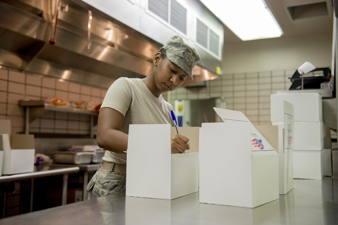 U.S. Air Force Senior Airman Darielle Williams, an 18th Force Support Squadron services journeyman assigned to Kadena Air Base, Japan, labels flight meals, May 11, 2016, at Eielson Air Force Base, Alaska. Williams made anywhere from 25 to 40 boxes a day for members who needed food “on the go” during RED FLAG-Alaska 16-1. (U.S. Air Force photo by Staff Sgt. Ashley Nicole Taylor/Released)