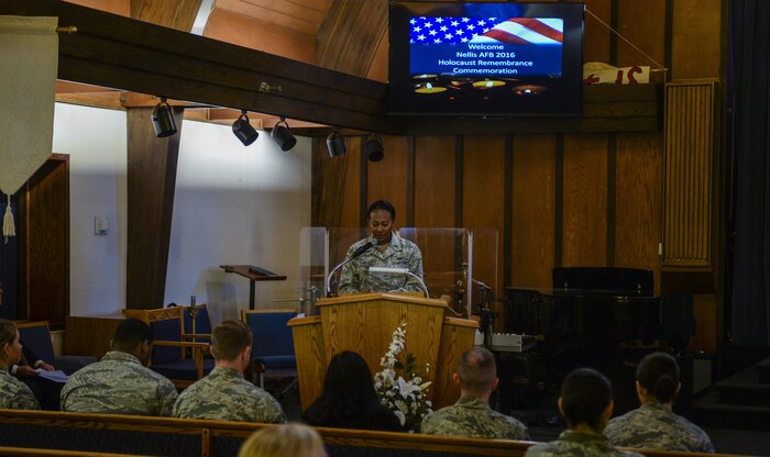 1st Lt. Liza Flint, United States Air Force Warfare Center Deputy Director, speaks at the Holocaust Remembrance Commemoration and Candle Lighting Ceremony at Nellis Air Force Base, Nev., May 9, 2016. To raise awareness and help educate the men and women on Nellis AFB, Several events took place May 6 to May 13 as part of Holocaust Remembrance Week. (U.S. Air Force photo by Airman 1st Class Kevin Tanenbaum)