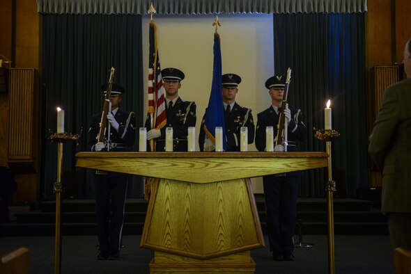 The Nellis Air Force Base Honor Guard presents the colors at the Holocaust Remembrance Commemoration and Candle Lighting Ceremony at Nellis AFB, Nev., May 9, 2016. During the event, Holocaust survivors light candles to raise awareness. (U.S. Air Force photo by Airman 1st Class Kevin Tanenbaum)
