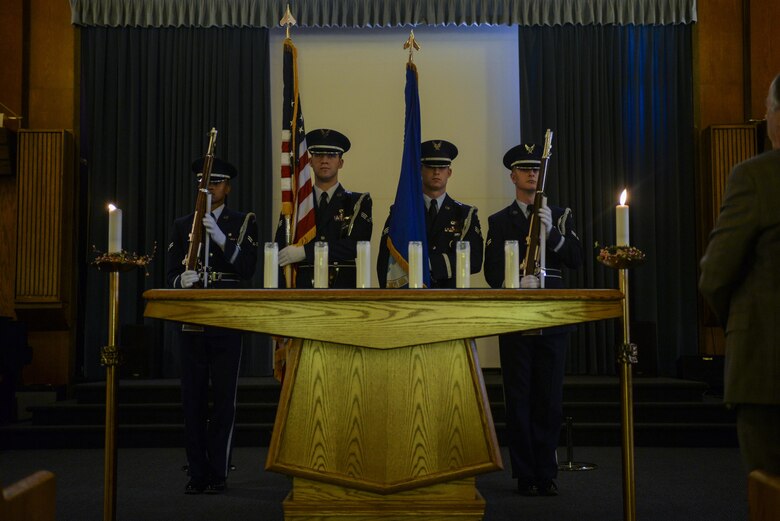 The Nellis Air Force Base Honor Guard presents the colors at the Holocaust Remembrance Commemoration and Candle Lighting Ceremony at Nellis AFB, Nev., May 9, 2016. During the event, Holocaust survivors light candles to raise awareness. (U.S. Air Force photo by Airman 1st Class Kevin Tanenbaum)
