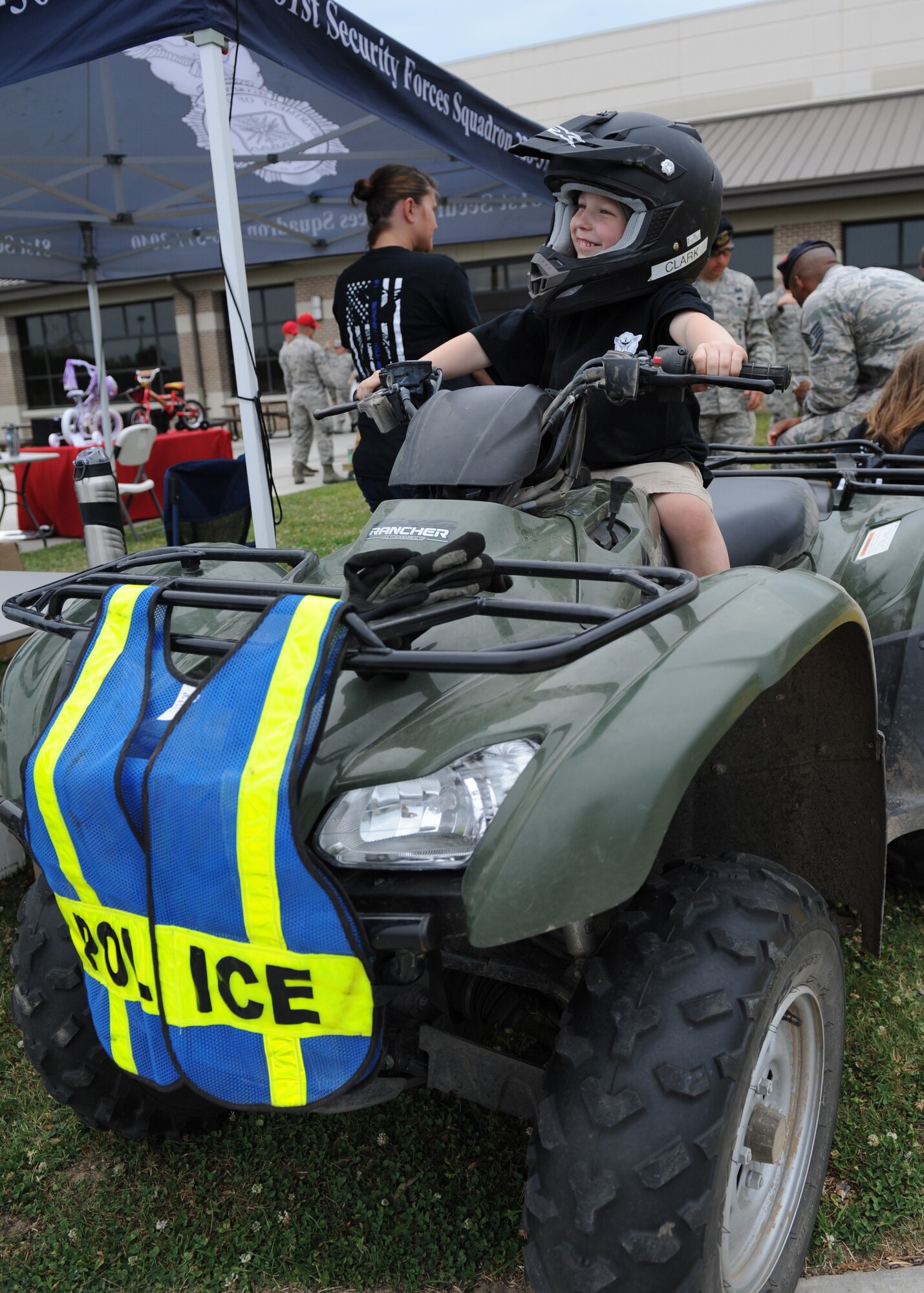 Jaxsen Sproston, son of Maj. Devin Sproston, 81st Security Forces Squadron commander, sits on an all-terrain vehicle during the 81st SFS Fun Day at the base exchange May 16, 2016, Keesler Air Force Base, Miss. The event was held during National Police Week, which recognizes the service of law enforcement men and women who put their lives at risk every day. (U.S. Air Force photo by Kemberly Groue)