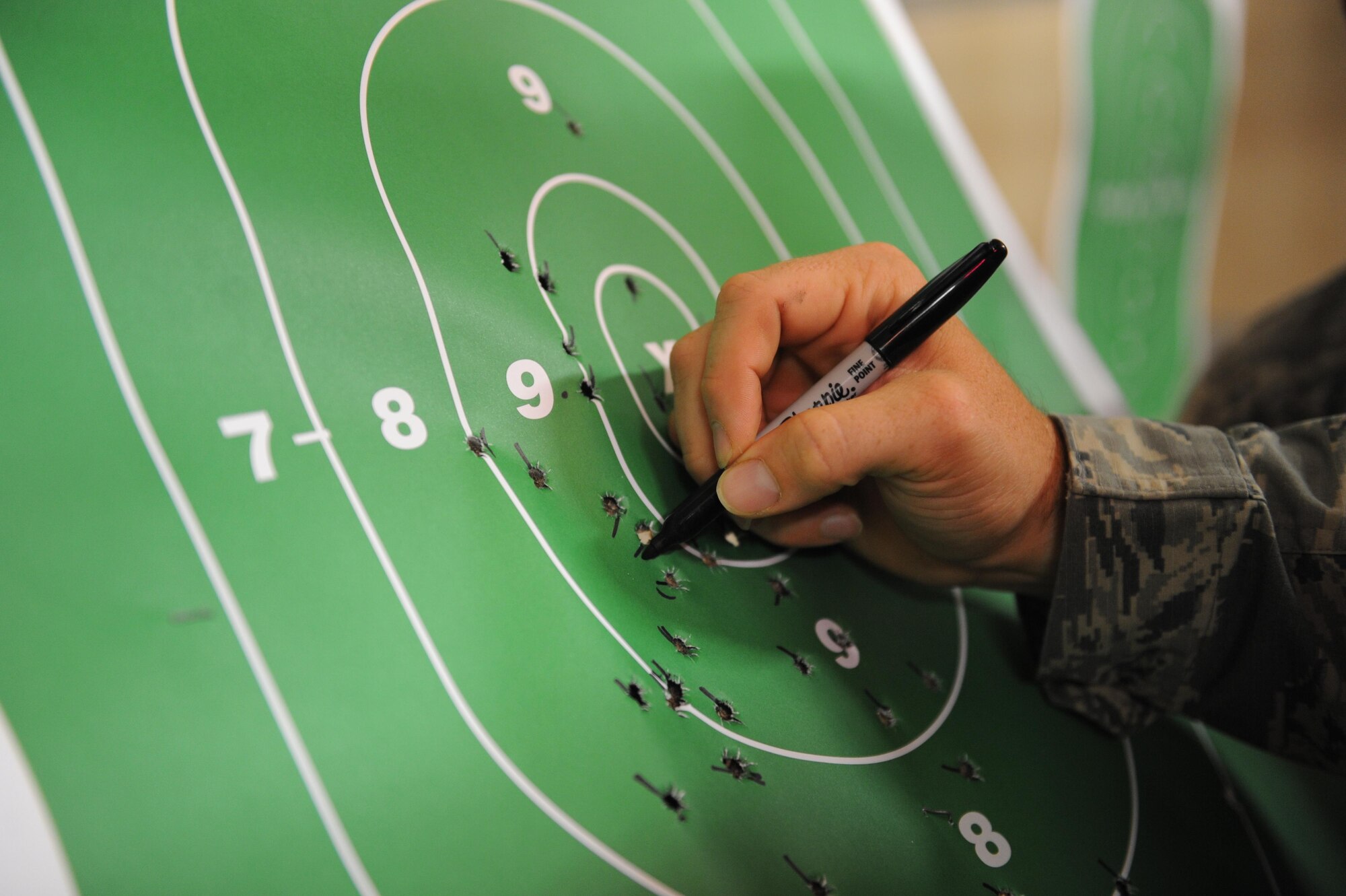 Staff Sgt. Jared Miller, 81st Security Forces Squadron combat arms instructor, calculates scores on targets during the 81st SFS Law Enforcement Team Competition May 18, 2016, Keesler Air Force Base, Miss. The competition was held during National Police Week, which recognizes the service of law enforcement men and women who put their lives at risk every day. (U.S. Air Force photo by Kemberly Groue)