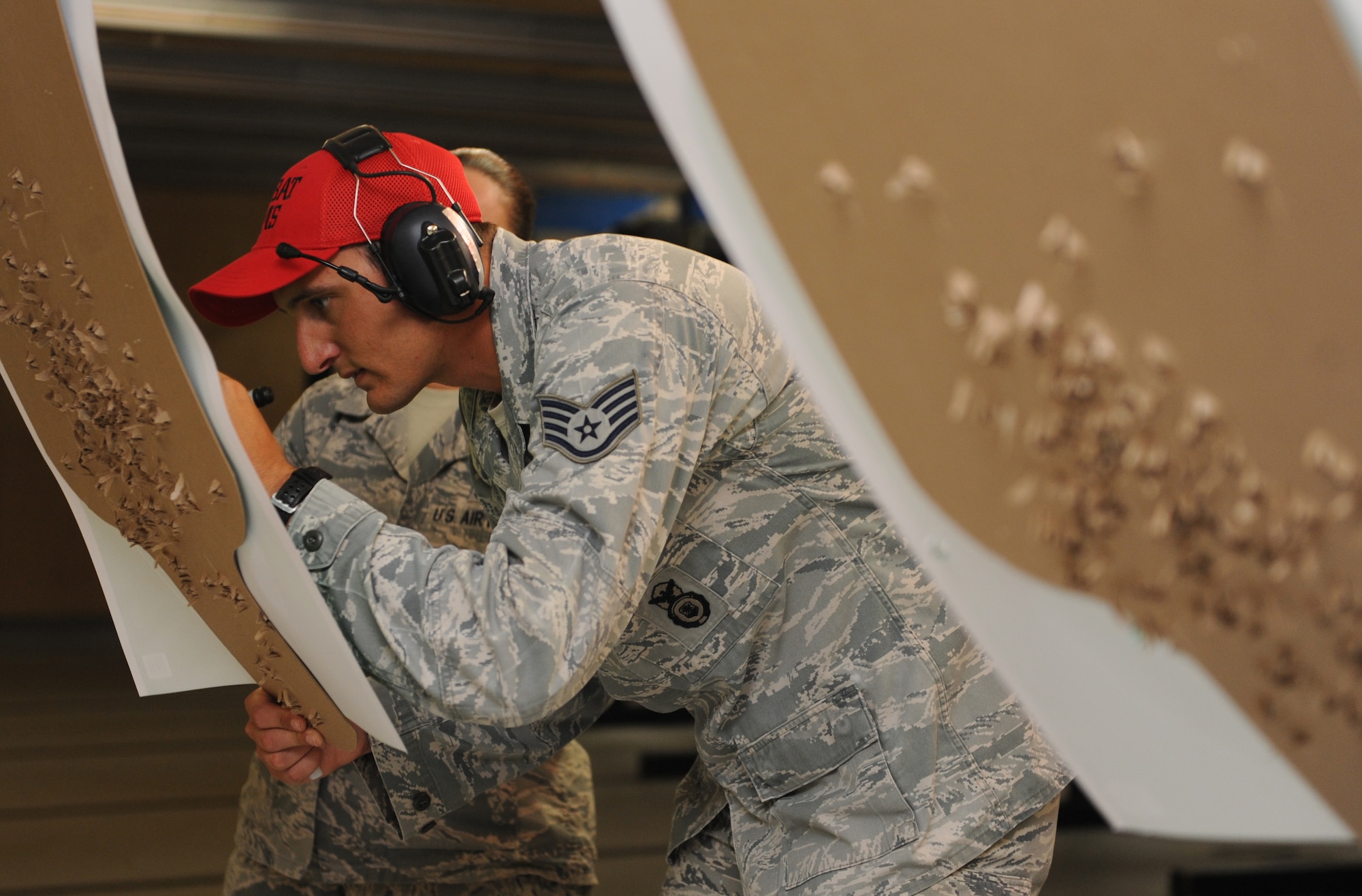 Staff Sgt. Joshua Green, 81st Security Forces Squadron combat arms instructor, calculates scores on targets during the 81st SFS Law Enforcement Team Competition May 18, 2016, Keesler Air Force Base, Miss. The competition was held during National Police Week, which recognizes the service of law enforcement men and women who put their lives at risk every day. (U.S. Air Force photo by Kemberly Groue)