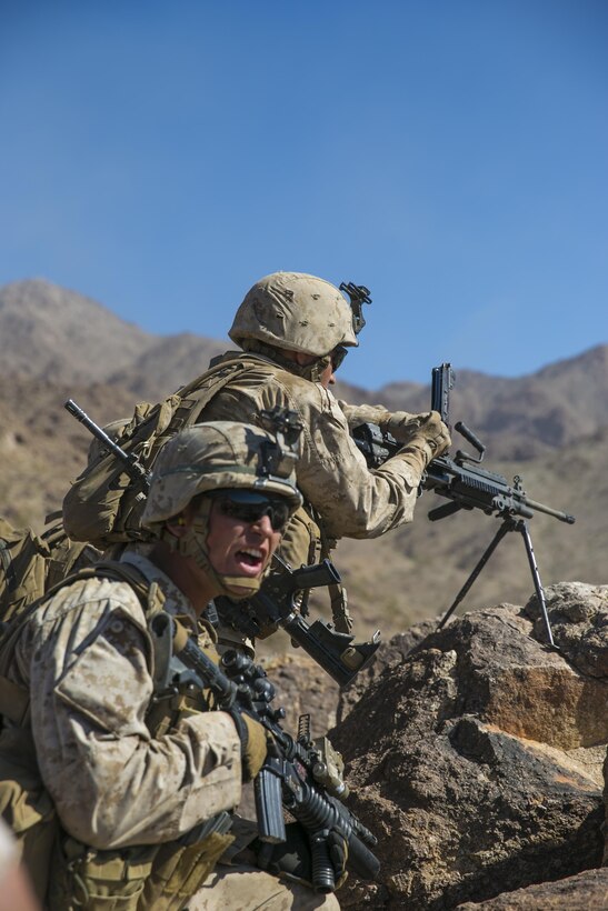 Lance Cpl. Geovanny Nunez, rifleman, 2nd Battalion, 8th Marine Regiment, reloads the M240B machinegun while Lance Cpl. Jacob Mills, rifleman, 2/8 informs the other machine gunners of Nunez’s reload at Range 410 while participating in Integrated Training Exercise 3-16 aboard Marine Corps Air Ground Combat Center, Twentynine Palms, Calif., May 9, 2016. 2/8 came from Marine Corps Base Camp Lejeune, N.C., to participate in ITX 3-16. (Official Marine Corps photo by Lance Cpl. Dave Flores/Released)