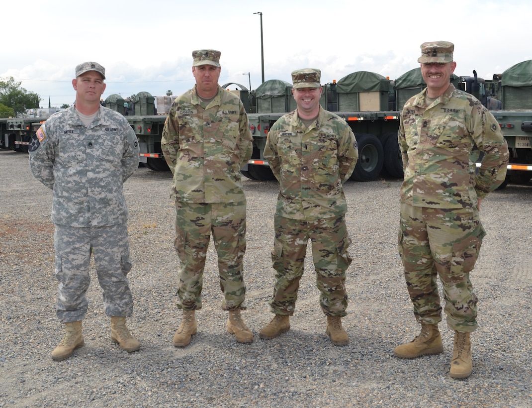 Staff Sgt. Adam Doyle, 729th Transportation Company non-commissioned officer, Staff Sgt. Ricky Cannon, 729th TC NCO, 1st Lt. Kyle Brown, 729th TC company commander, and Master Sgt. Brian Carlin, 729th TC non-commissioned officer in-charge, ready themselves to lead their transportation unit through a Nationwide Move exercise that will take them through five states and onto to Operation Maple Resolve, which is being conducted at Canadian Forces Base Wainwright, east of Edmonton, Canada.