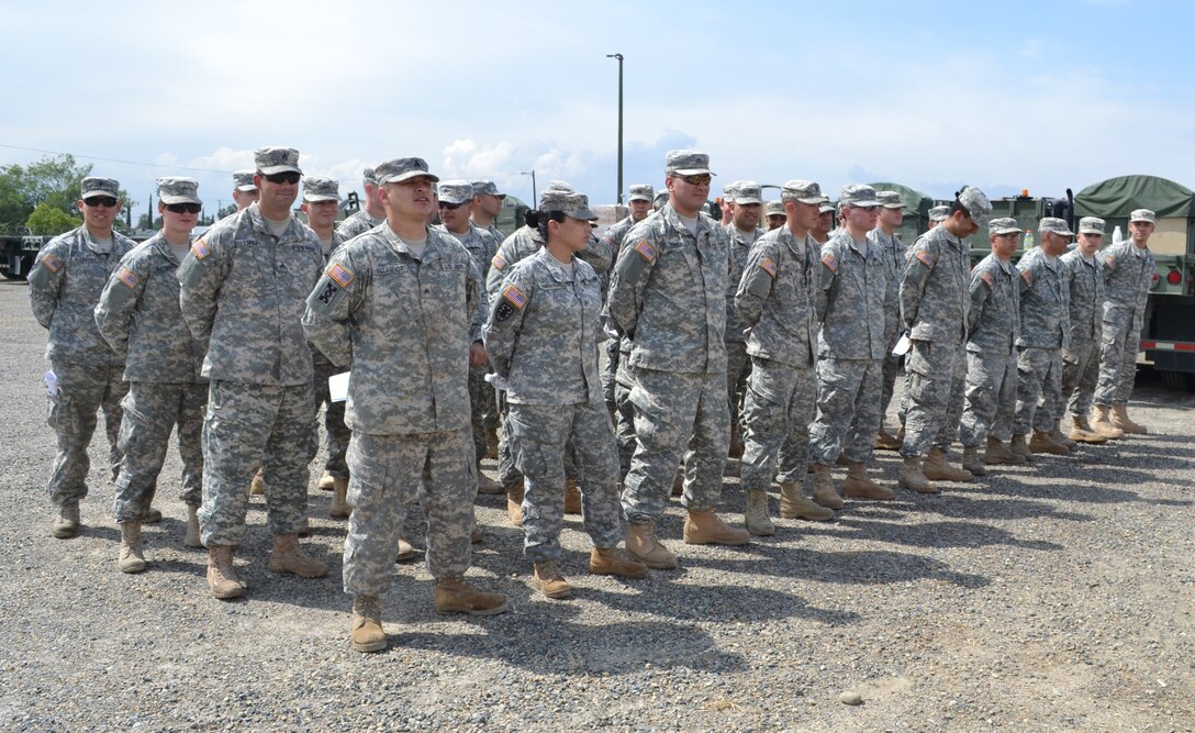 Soldiers from the 729th Transportation Company stand at ease before they start their drive, during the Nationwide Move exercise that will take them through five states and onto to Operation Maple Resolve, which is being conducted at Canadian Forces Base Wainwright, east of Edmonton, Canada. The Nationwide Move exercise is an opportunity for transportation units throughout the U.S. Army to use their driving skills.