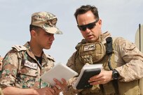 A U.S. Marine and a Jordanian Armed Forces servicemember prepare to call in a Cobra Helicopter during a Quick Reaction Force drill during Exercise Eager Lion 2016 near Amman, Jordan, 18, May, 2016. Eager Lion 16 is a bi-lateral exercise in the Hashemite Kingdom of Jordan between the JAF and the U.S. Military designed to strengthen relationships and interoperability between partner nations. (U.S. Army Reserve photo by Spc. Ian Valley 366 Mobile Public Affairs Detachment.)