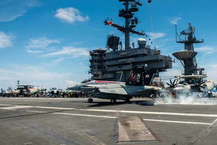 160511-N-MY174-044 SOUTH CHINA SEA (May 11, 2016) Capt. Richard Brophy, commander, Carrier Air Wing (CVW) 9 lands an F/A-18E Super Hornet assigned to the Tophatters of Strike Fighter Squadron (VFA) 14 on USS John C. Stennis' (CVN 74) flight deck during routine flight operations. This marks Brophy's 1,000th arrested landing on an aircraft carrier. Providing a ready force supporting security and stability in the Indo-Asia-Pacific, John C. Stennis is operating as part of the Great Green Fleet on a regularly scheduled 7th Fleet deployment. (U.S. Navy photo by Mass Communication Specialist Seaman Tomas Compian/Released)