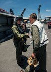160511-N-MY174-061: SOUTH CHINA SEA (May 11, 2016) - Rear Adm. Marcus Hitchcock, commander, John C. Stennis Strike Group (JCSSG), congratulates Capt. Richard Brophy, commander, Carrier Air Wing (CVW) 9, on the 1,000th arrested landing of his career. Brophy reached the milestone landing an F/A-18E Super Hornet assigned to the Tophatters of Strike Fighter Squadron (VFA) 14 on USS John C. Stennis' (CVN 74) flight deck. Providing a ready force supporting security and stability in the Indo-Asia-Pacific, John C. Stennis is operating as part of the Great Green Fleet on a regularly scheduled 7th Fleet deployment. (U.S. Navy photo by Mass Communication Specialist Seaman Tomas Compian/ Released)