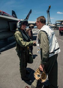 160511-N-MY174-061: SOUTH CHINA SEA (May 11, 2016) - Rear Adm. Marcus Hitchcock, commander, John C. Stennis Strike Group (JCSSG), congratulates Capt. Richard Brophy, commander, Carrier Air Wing (CVW) 9, on the 1,000th arrested landing of his career. Brophy reached the milestone landing an F/A-18E Super Hornet assigned to the Tophatters of Strike Fighter Squadron (VFA) 14 on USS John C. Stennis' (CVN 74) flight deck. Providing a ready force supporting security and stability in the Indo-Asia-Pacific, John C. Stennis is operating as part of the Great Green Fleet on a regularly scheduled 7th Fleet deployment. (U.S. Navy photo by Mass Communication Specialist Seaman Tomas Compian/ Released)