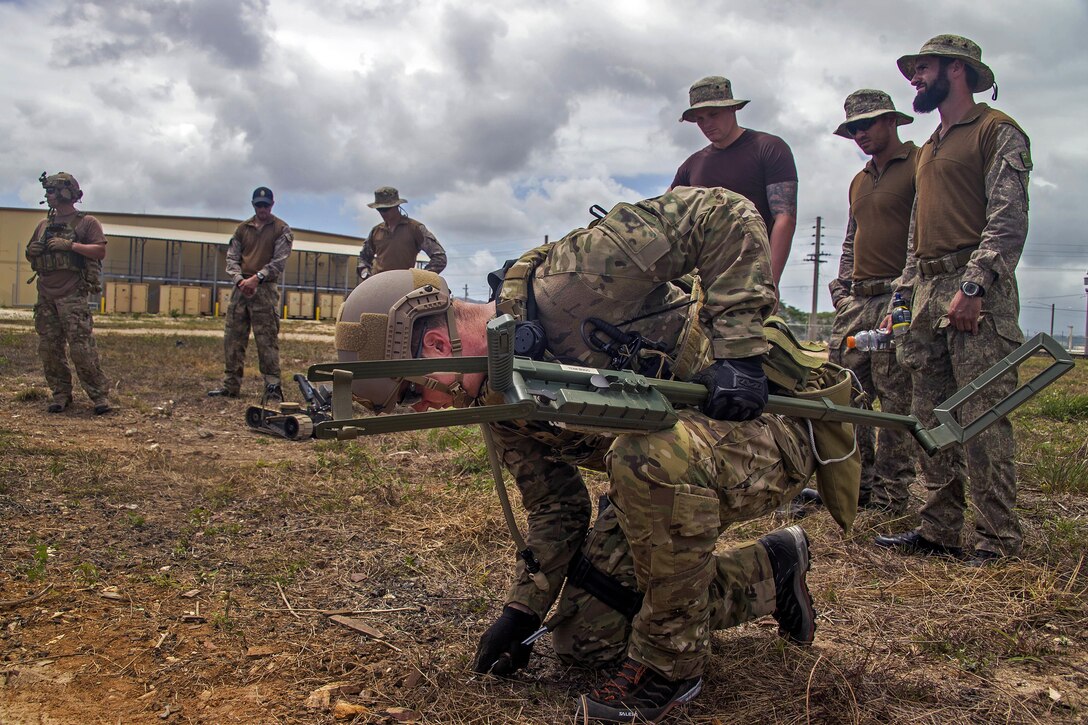 A U.S. sailor, foreground, searches for an Improvised Explosive Device during an IED training scenario as part of Exercise Tricrab at Naval Base Guam, May 09, 2016. Navy photo by Petty Officer 3rd Class Alfred A. Coffield