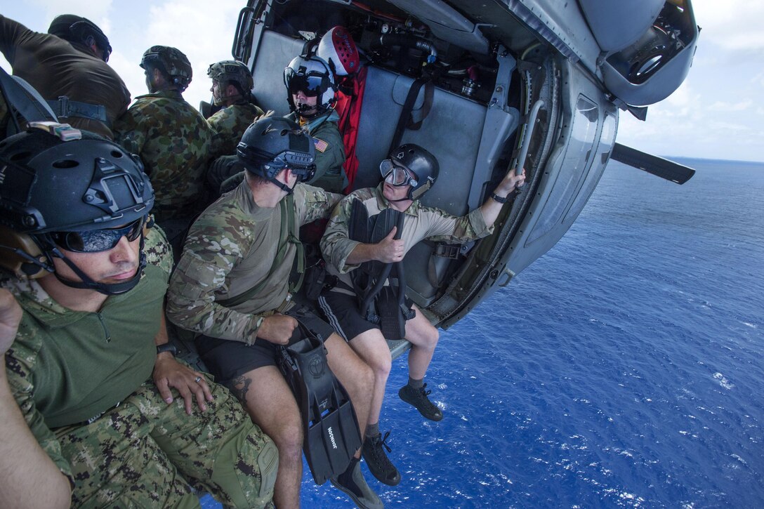 U.S. and Australian sailors prepare to fast-rope from a MH-60S Seahawk helicopter during Exercise Tricrab off the coast of Guam, May 10, 2016. Navy photo by Petty Officer 1st Class Doug Harvey