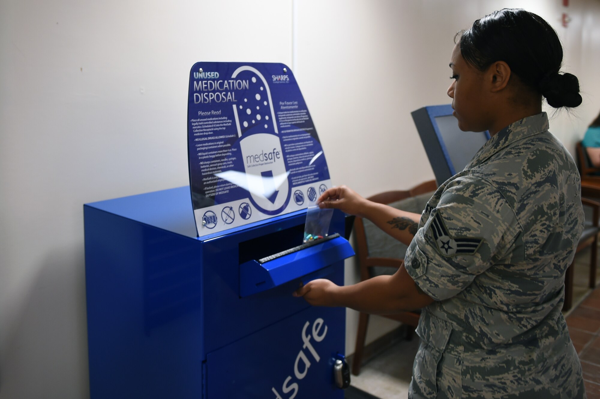Senior Airman Sierra Steen, 59th Medical Diagnostics and Therapeutics Squadron, pharmacy tech, drops off unused medications in the MedSafe cabinet, Apr. 21, 2016, at the Wilford Hall Ambulatory Surgical Center Pharmacy lobby on Joint Base San Antonio-Lackland, Texas. Secure medicine collection cabinets are located in the WHASC lobby first floor near Seattle’s Best, in the Satellite Pharmacy lobby and at the Reid Clinic just outside the pharmacy. (U.S. Air Force photo/Staff Sgt. Jason Huddleston)